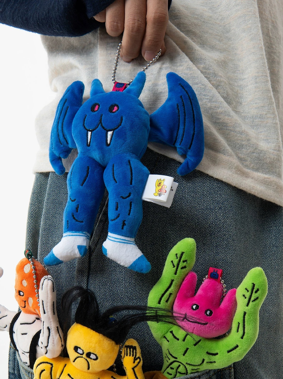 wulibuddy Goblin Bobo plush muscle character bag charm hanging in a black bag