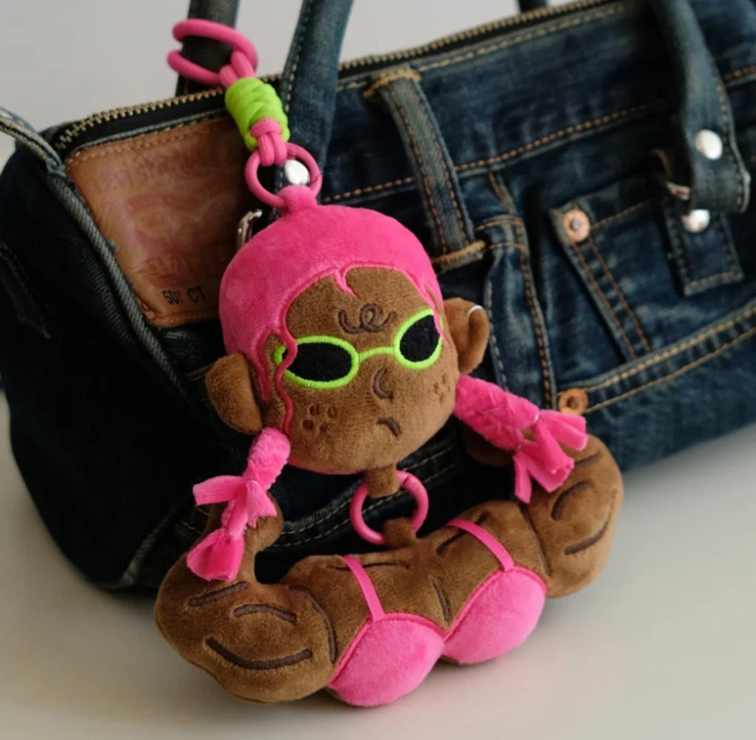wulibuddy Dark Skin  Baddie plush character bag charm attached to a denim handbag