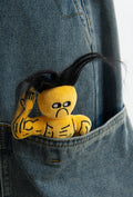 wulibuddy Street Wizard plush muscle character bag charm with black hair and flexed arm pocketed in a blue denim jacket