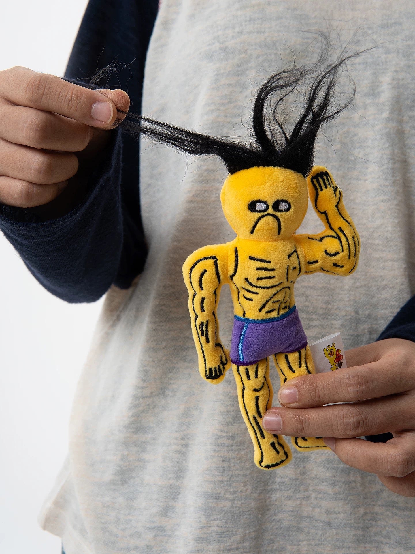 wulibuddy Street Wizard plush muscle character bag charm flipped his hair and showed leave me alone face held in hands