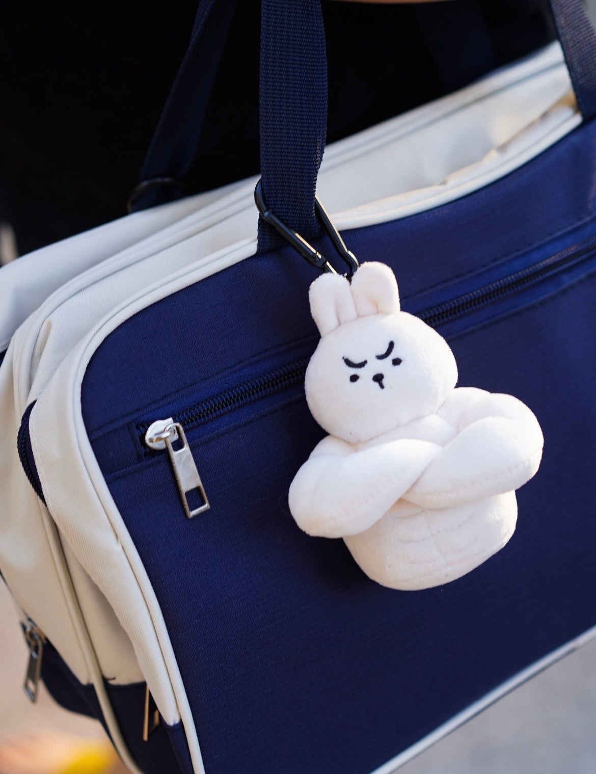 wulibuddy Rabbit Coach Buddy plush Bag Charm&keychain accessoryhanging from a blue bag strap