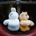 wulibuddy_white-coach_rabbit_and_brown-bear_plush_bag_charms_keychains_accessories back to back both have serious face crossed their arms